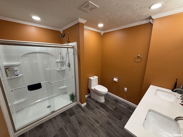 15293 Wall St, Carterville, IL 62918 - full bathroom featuring a stall shower, wood finished floors, crown molding, double vanity, and a textured ceiling