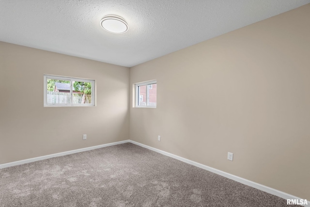 5210 N Division St, Davenport, IA 52806 - carpeted empty room with baseboards and a textured ceiling