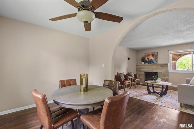5210 N Division St, Davenport, IA 52806 - dining space with arched walkways, hardwood / wood-style flooring, ceiling fan, and a fireplace