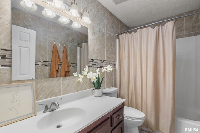 5210 N Division St, Davenport, IA 52806 - bathroom with tile walls, vanity, shower / tub combo with curtain, tasteful backsplash, and a textured ceiling