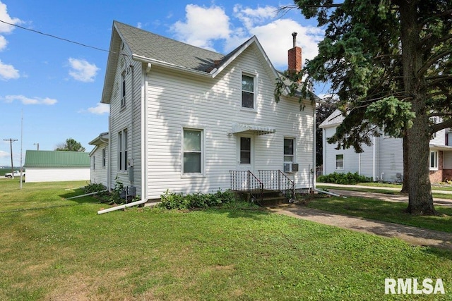 202 Washington Ave, Osco, IL 61274 - view of front of home featuring a chimney, a front yard, cooling unit, and a shingled roof