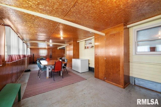 202 Washington Ave, Osco, IL 61274 - dining area featuring wood walls and concrete floors