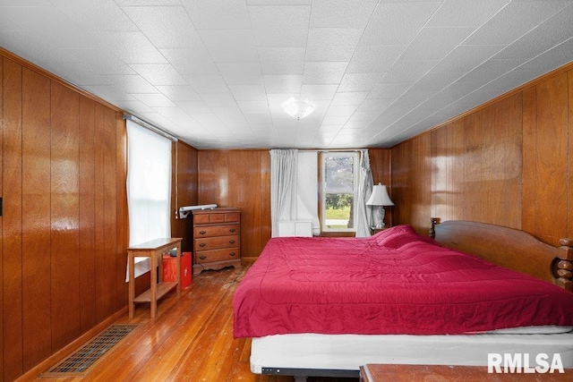 202 Washington Ave, Osco, IL 61274 - bedroom with wooden walls and wood finished floors