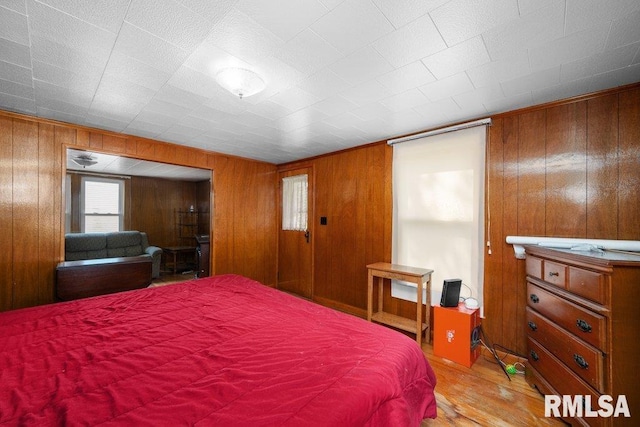 202 Washington Ave, Osco, IL 61274 - bedroom featuring wood finished floors and wooden walls