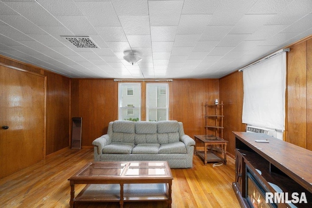 202 Washington Ave, Osco, IL 61274 - living room featuring light wood-type flooring and wooden walls