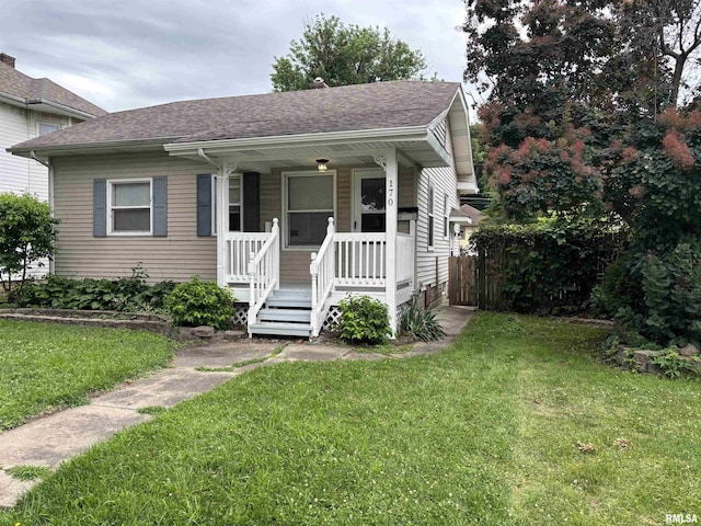170 16th Ave, East Moline, IL 61244 - view of front of home with covered porch, roof with shingles, and a front lawn