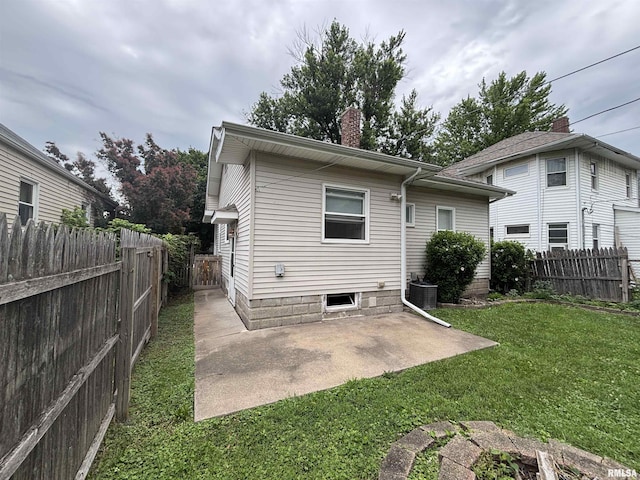 170 16th Ave, East Moline, IL 61244 - back of house featuring a patio area, a fenced backyard, and a chimney
