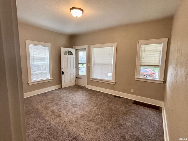 170 16th Ave, East Moline, IL 61244 - spare room with dark colored carpet