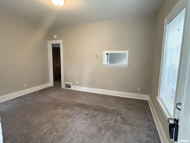 170 16th Ave, East Moline, IL 61244 - empty room with dark colored carpet and healthy amount of natural light