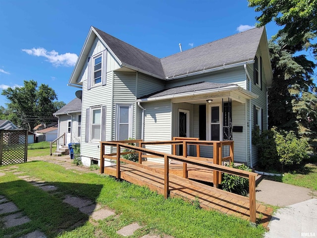 819 12th Ave S, Clinton, IA 52732 - view of front facade featuring a shingled roof, a front lawn, entry steps, and a deck