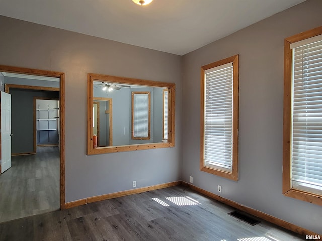 819 12th Ave S, Clinton, IA 52732 - spare room with wood finished floors and ceiling fan