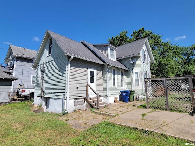 819 12th Ave S, Clinton, IA 52732 - rear view of house with entry steps, a shingled roof, and a patio area