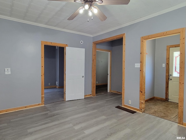 819 12th Ave S, Clinton, IA 52732 - spare room featuring ceiling fan, wood finished floors, and ornamental molding