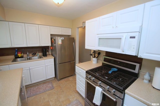 3422 Hobson Ave, Davenport, IA 52802 - kitchen with appliances with stainless steel finishes, white cabinetry, and light countertops