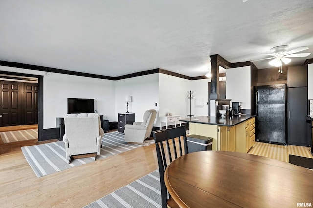 1800 7th St Unit 10E, East Moline, IL 61244 - dining area featuring light wood-type flooring, ornamental molding, and a ceiling fan