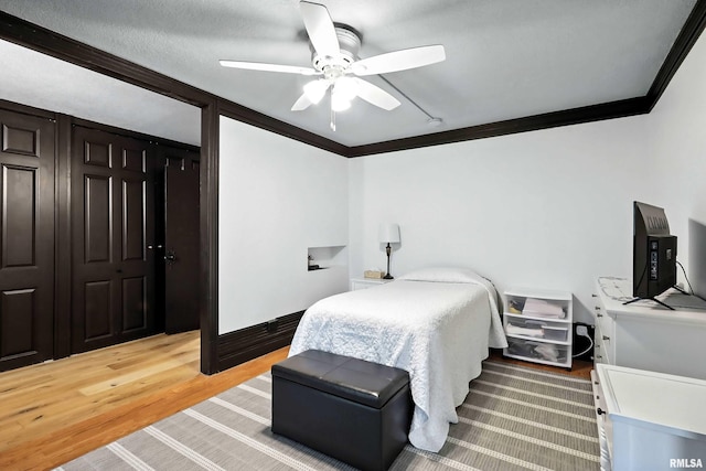 1800 7th St Unit 10E, East Moline, IL 61244 - bedroom featuring crown molding, light wood finished floors, a ceiling fan, and a closet