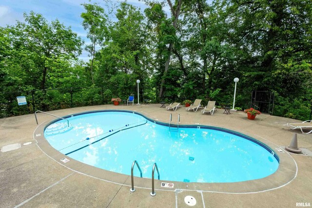 1800 7th St Unit 10E, East Moline, IL 61244 - community pool featuring a patio and view of wooded area