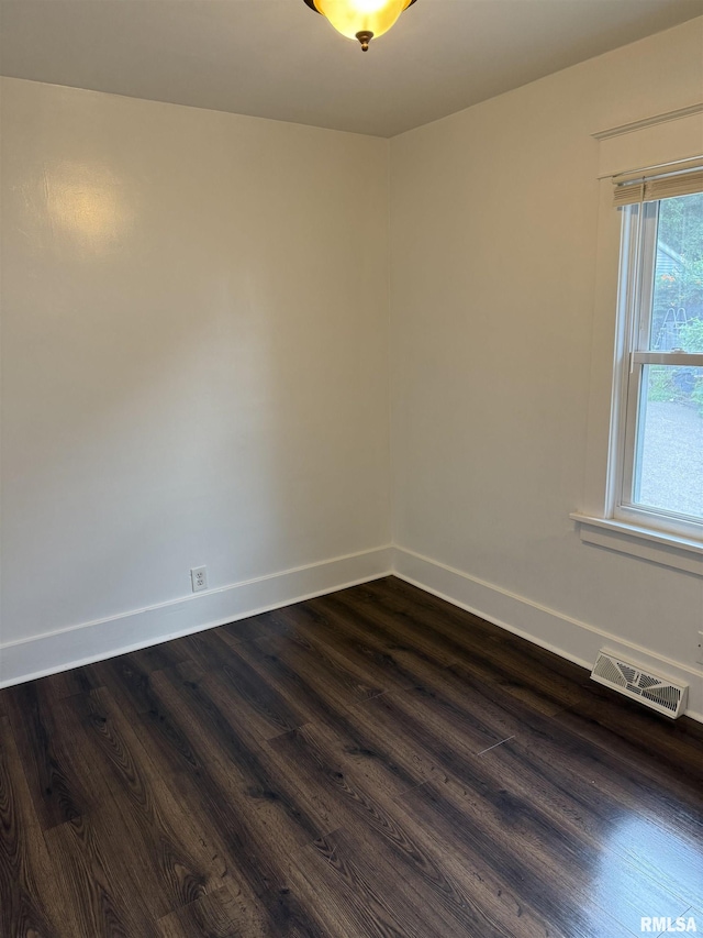 235 20th Pl, Clinton, IA 52732 - spare room with dark wood-type flooring and baseboards