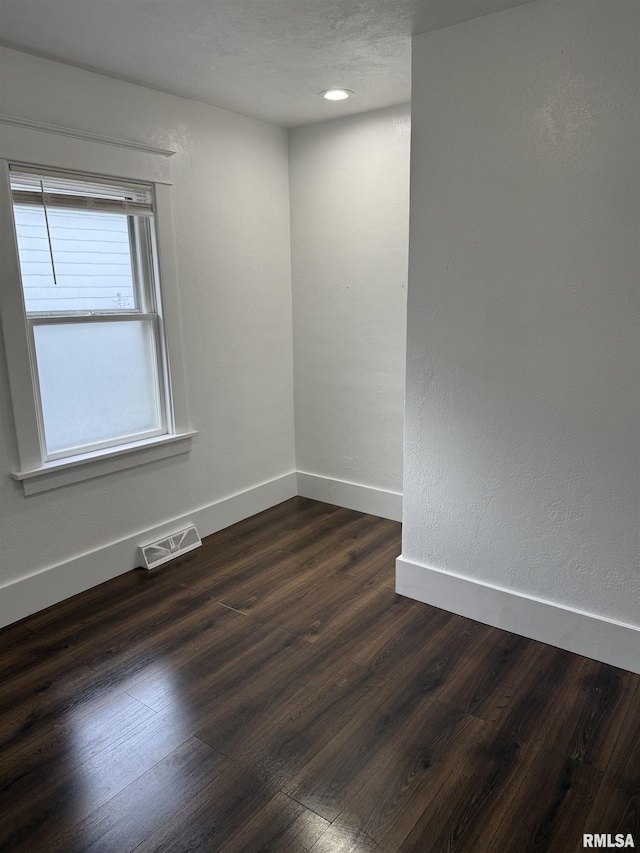 235 20th Pl, Clinton, IA 52732 - spare room featuring dark wood finished floors and baseboards