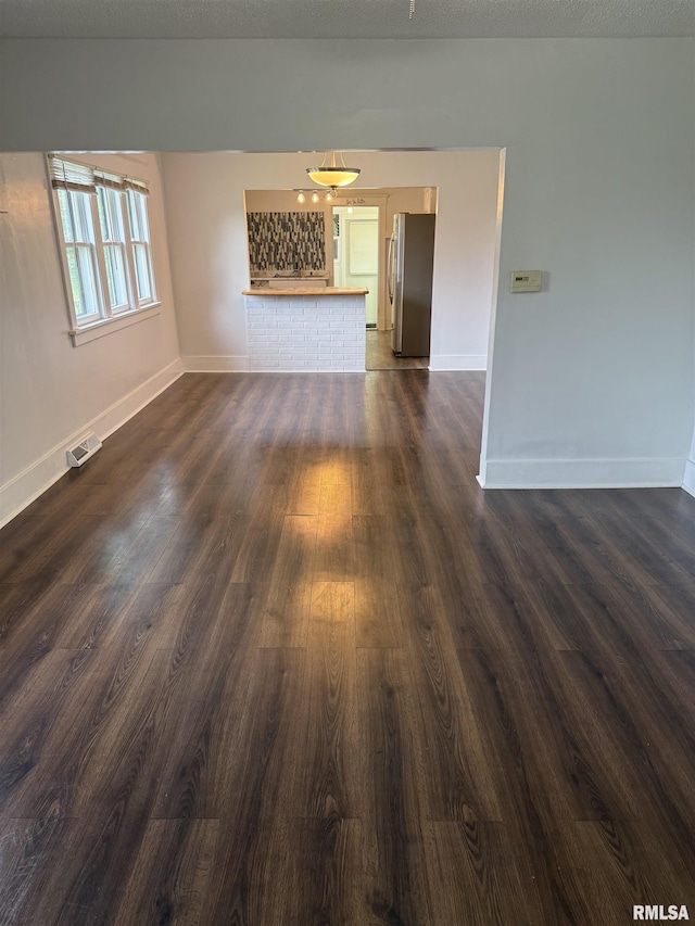 235 20th Pl, Clinton, IA 52732 - spare room featuring baseboards and dark wood-style floors