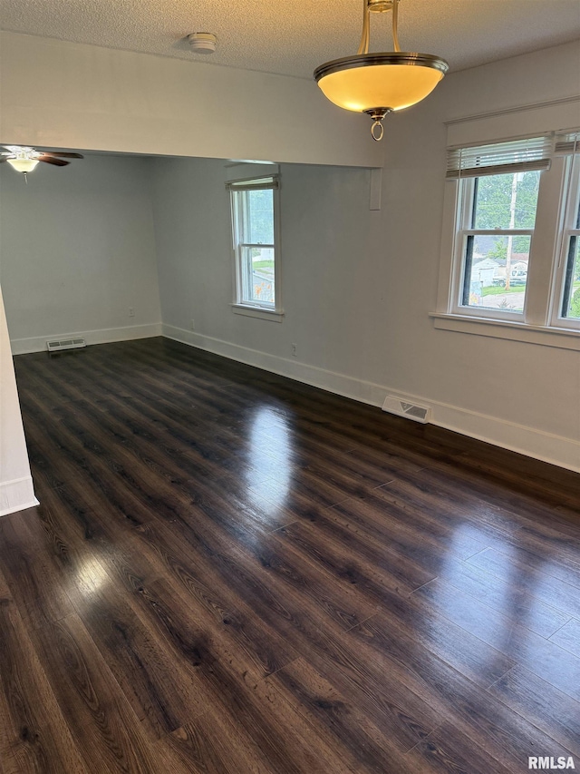 235 20th Pl, Clinton, IA 52732 - unfurnished room with dark wood-style floors, a textured ceiling, and a ceiling fan