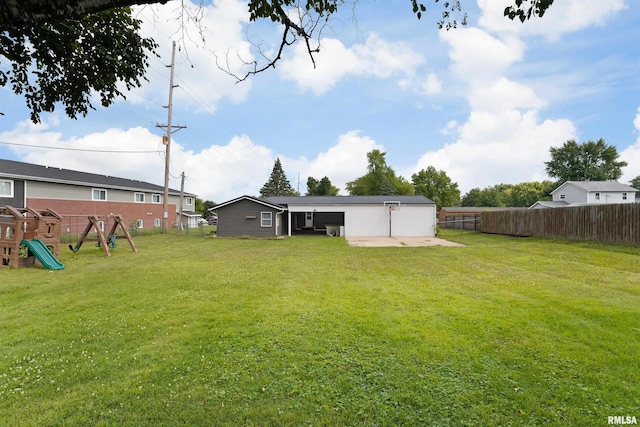 1217 7th St, De Witt, IA 52742 - fenced backyard with a playground and a patio