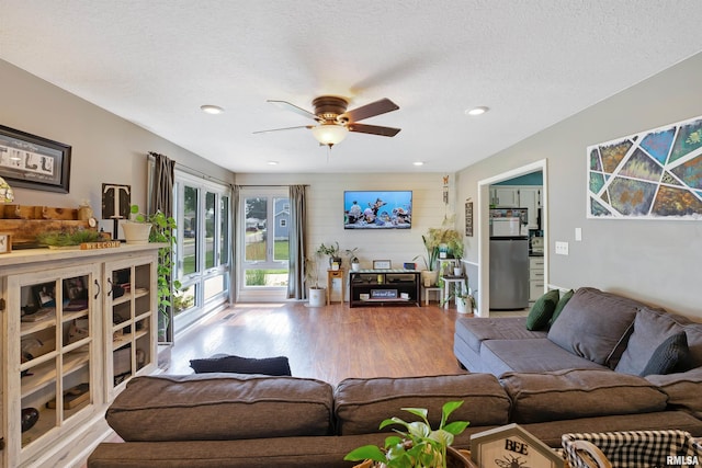 1217 7th St, De Witt, IA 52742 - living room with wood finished floors, a ceiling fan, and recessed lighting
