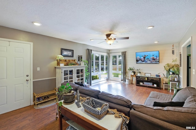 1217 7th St, De Witt, IA 52742 - living area with dark wood-type flooring, a textured ceiling, a ceiling fan, and recessed lighting