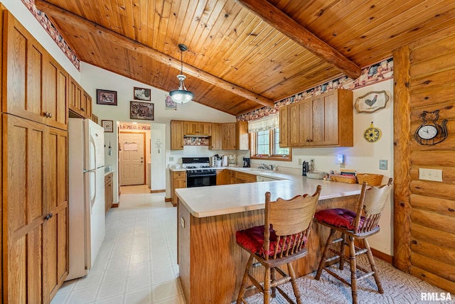 4830 Wyoming Ave, Davenport, IA 52806 - kitchen with white appliances, a peninsula, rustic walls, light countertops, and brown cabinetry