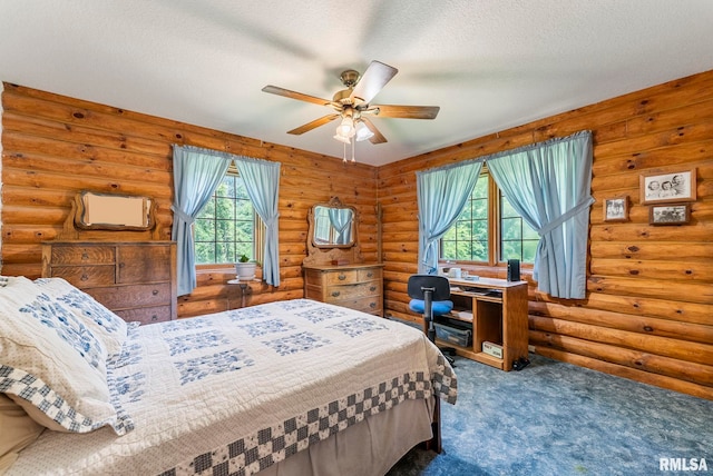 4830 Wyoming Ave, Davenport, IA 52806 - bedroom featuring carpet floors, log walls, a textured ceiling, and a ceiling fan