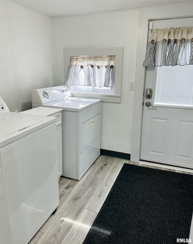 616 Elk St, Sabula, IA 52070 - laundry room with independent washer and dryer and light wood-style floors