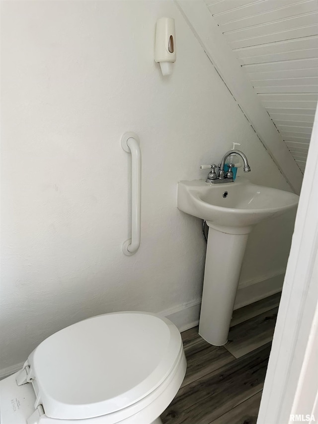 616 Elk St, Sabula, IA 52070 - half bathroom featuring toilet and wood finished floors