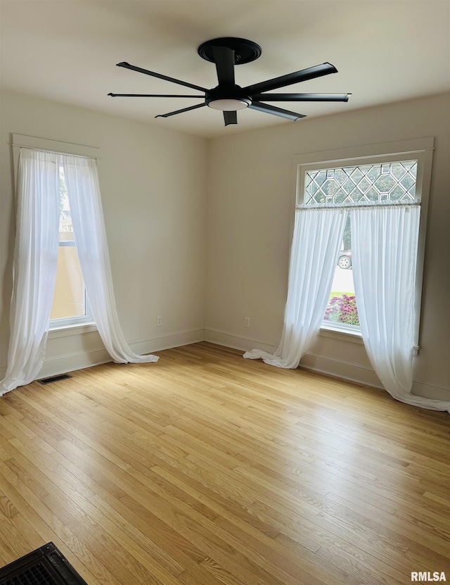 616 Elk St, Sabula, IA 52070 - unfurnished room with plenty of natural light, ceiling fan, and light wood-style flooring