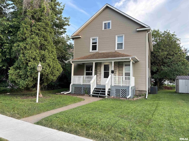 616 1st Ave, Silvis, IL 61282 - view of front of house with covered porch, a storage shed, and a front yard