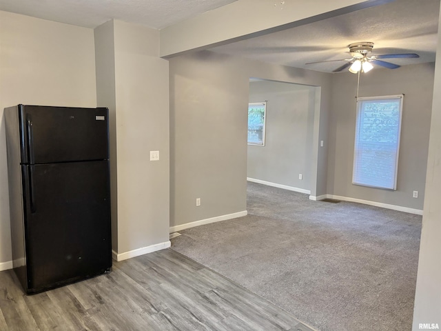 616 1st Ave, Silvis, IL 61282 - kitchen with freestanding refrigerator, ceiling fan, wood finished floors, and a textured ceiling