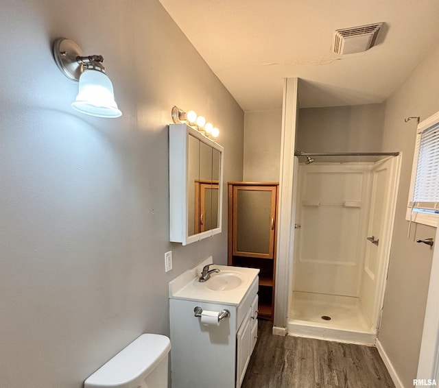 616 1st Ave, Silvis, IL 61282 - full bath featuring wood finished floors, vanity, and a walk in shower
