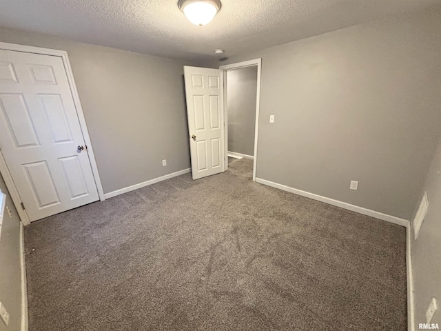 616 1st Ave, Silvis, IL 61282 - unfurnished bedroom featuring a textured ceiling and carpet floors