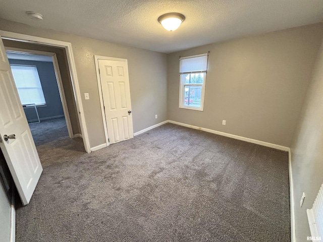 616 1st Ave, Silvis, IL 61282 - empty room with carpet flooring, a textured ceiling, and a smoke detector