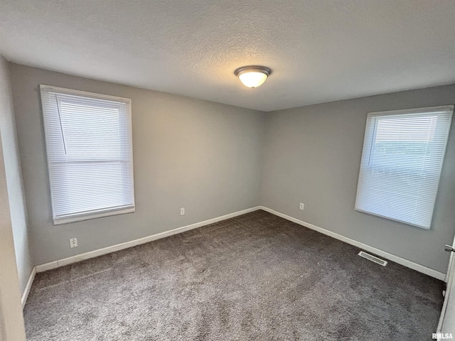 616 1st Ave, Silvis, IL 61282 - empty room featuring dark carpet and a textured ceiling