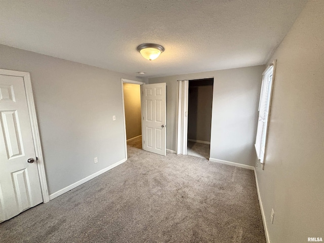 616 1st Ave, Silvis, IL 61282 - unfurnished bedroom with a textured ceiling, carpet floors, and a closet