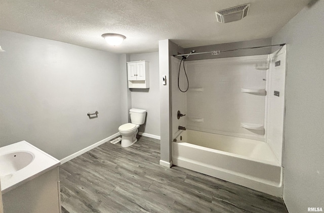 616 1st Ave, Silvis, IL 61282 - bathroom featuring washtub / shower combination, wood finished floors, vanity, and a textured ceiling