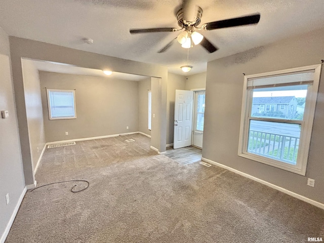 616 1st Ave, Silvis, IL 61282 - carpeted empty room with ceiling fan, a smoke detector, and a textured ceiling