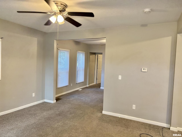 616 1st Ave, Silvis, IL 61282 - spare room featuring dark colored carpet, a ceiling fan, and a smoke detector