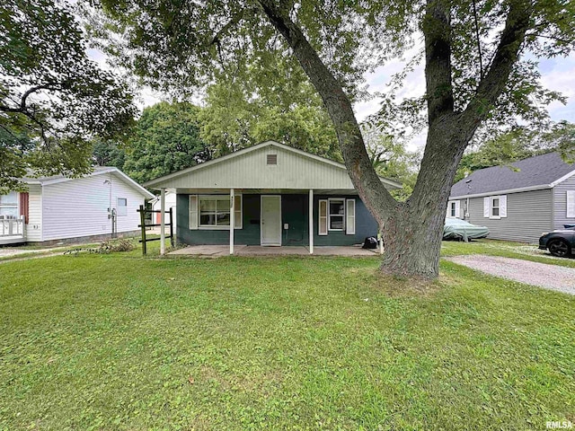 3327 2nd St, East Moline, IL 61244 - view of front facade featuring covered porch and a front lawn