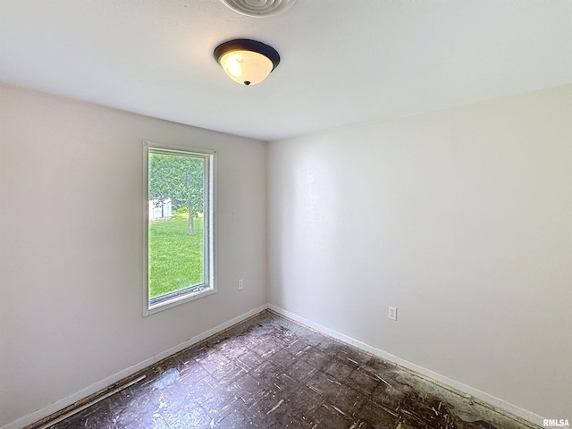 3327 2nd St, East Moline, IL 61244 - spare room with baseboards and dark flooring