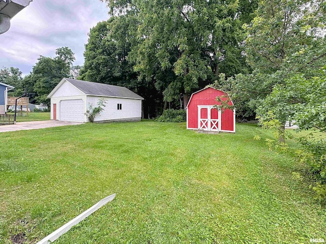 3327 2nd St, East Moline, IL 61244 - view of grassy yard with an outdoor structure, a detached garage, and view of scattered trees