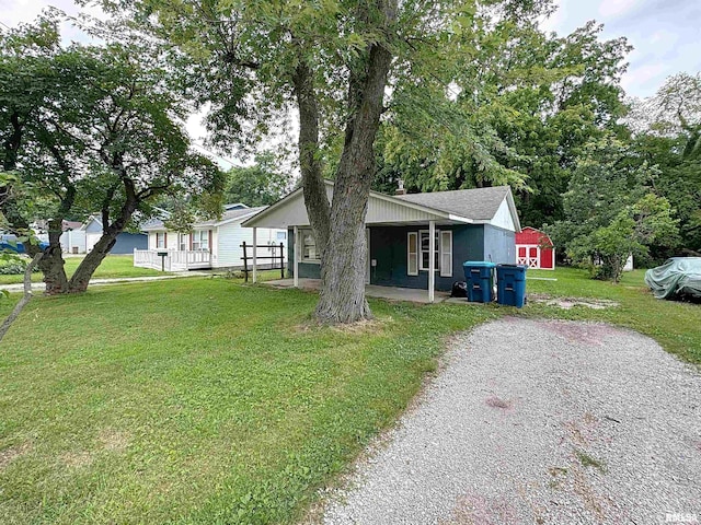 3327 2nd St, East Moline, IL 61244 - view of front of house with a front lawn and an outbuilding