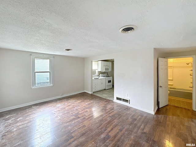 3327 2nd St, East Moline, IL 61244 - unfurnished living room featuring wood finished floors and a textured ceiling
