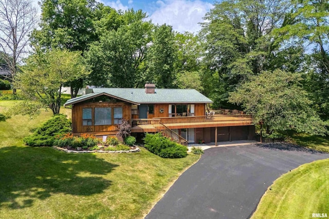 28002 230th St, Le Claire, IA 52753 - view of front of home with stairway, a front lawn, a chimney, asphalt driveway, and a deck