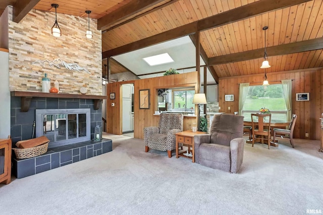 28002 230th St, Le Claire, IA 52753 - living area featuring carpet floors, wooden walls, wood ceiling, and a tile fireplace